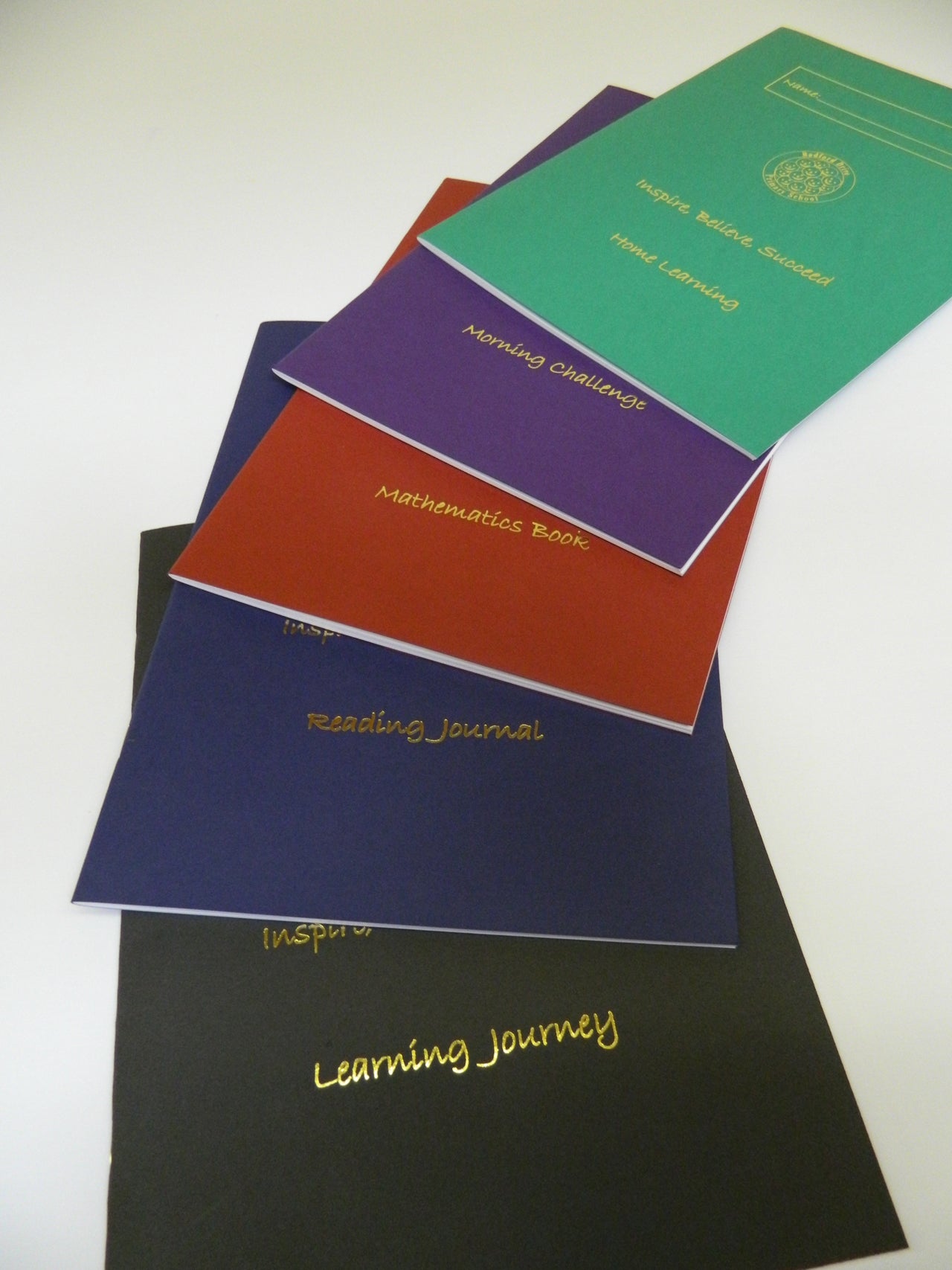 Selection of different coloured sketch books showing foil blocked logo