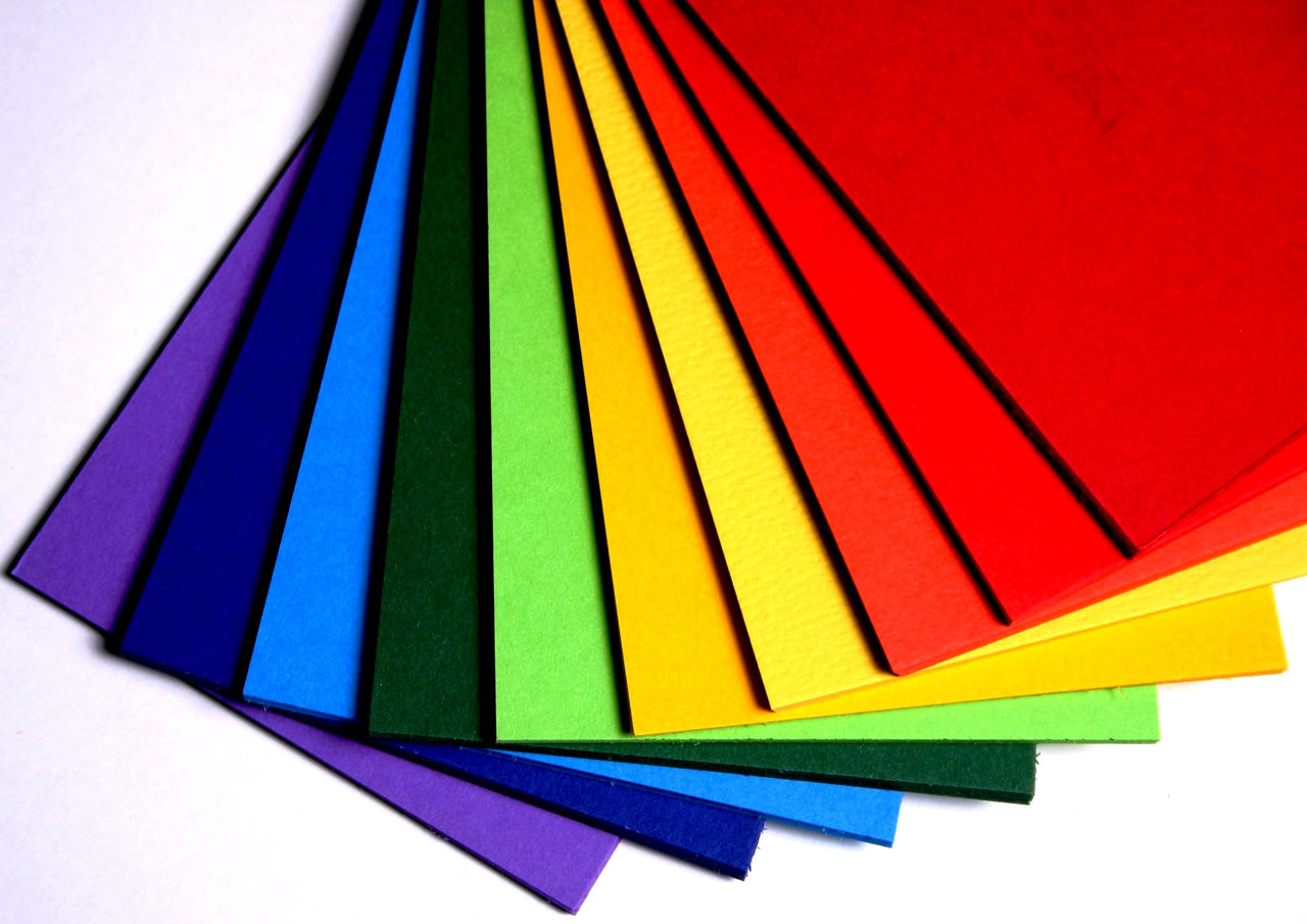 Ten colours of bright coloured card in rainbow order