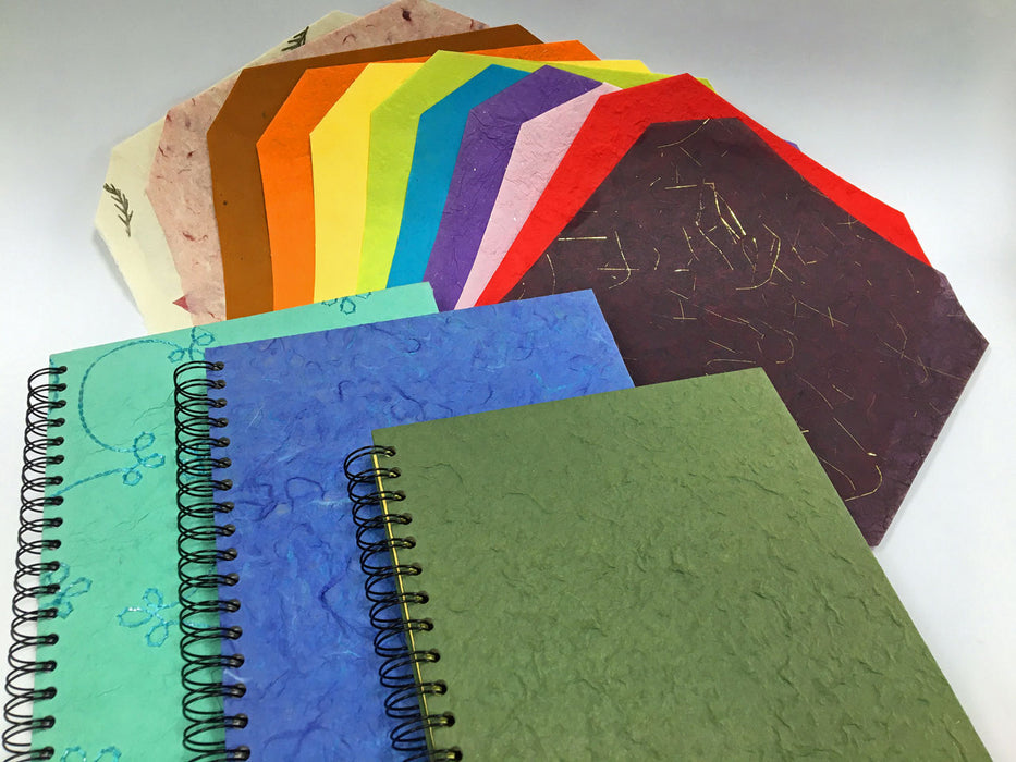 Selection of assorted handmade papers and spiral books made using the paper as covers