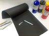 Heavyweight black sketch pad and bottles of ready mix paint