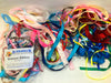 Pile of assorted lengths and colours of various different ribbons
