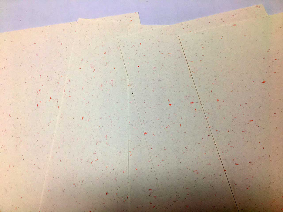 Sheets of off white card with red speckle