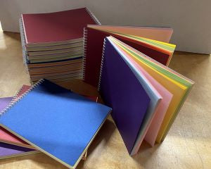 Stacks of assorted colour Sketch Books