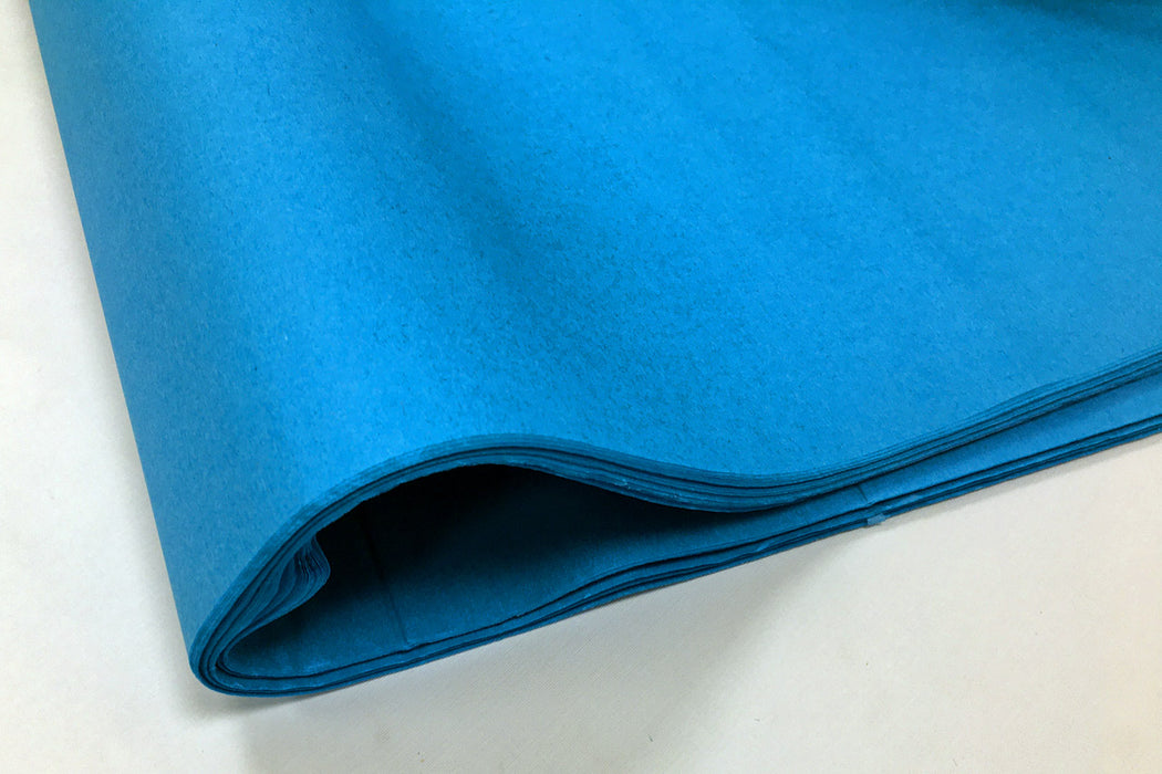 A fold of turquoise coloured tissue paper